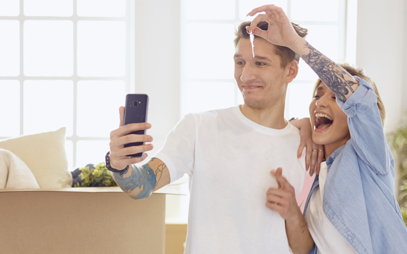 Young Couple Excited On The Phone Moving House